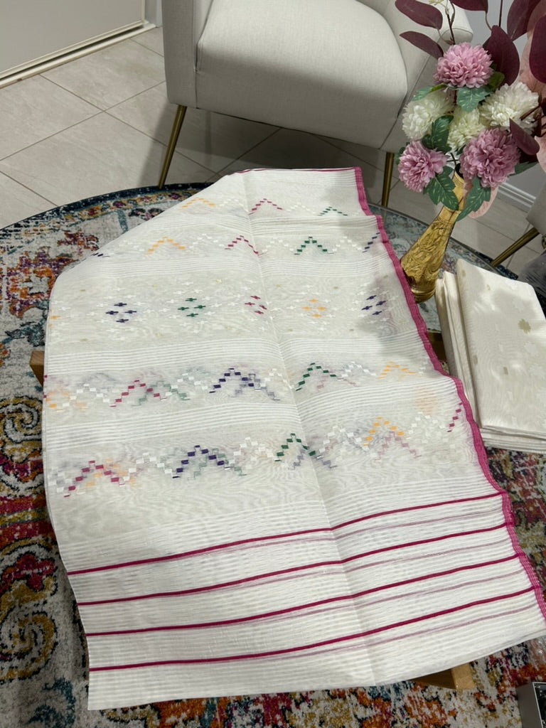 Half silk jamdani saree in a structured white texture with magenta stripes@Auxerra