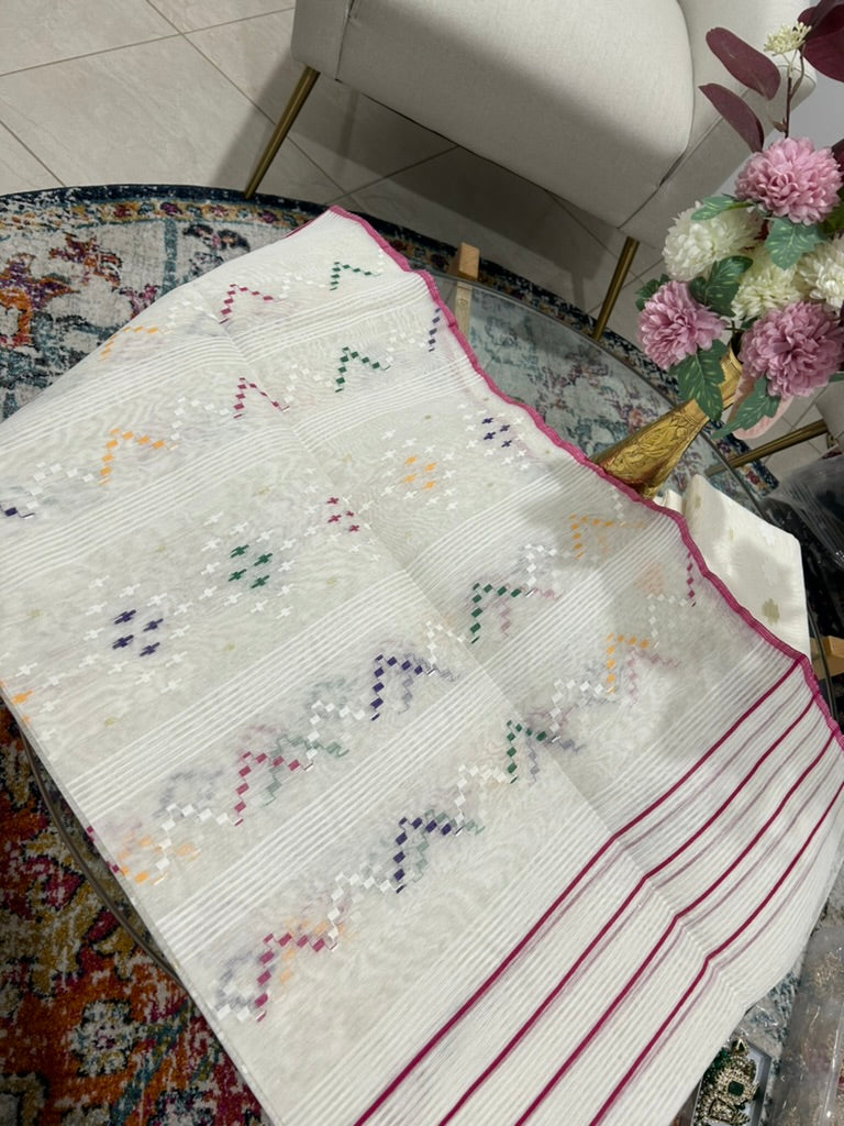 Half silk jamdani saree in a structured white texture with magenta stripes@Auxerra